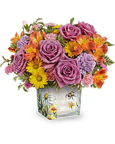 Mixed bouquet of purple roses, yellow daisies, and orange alstroemeria in a square vase