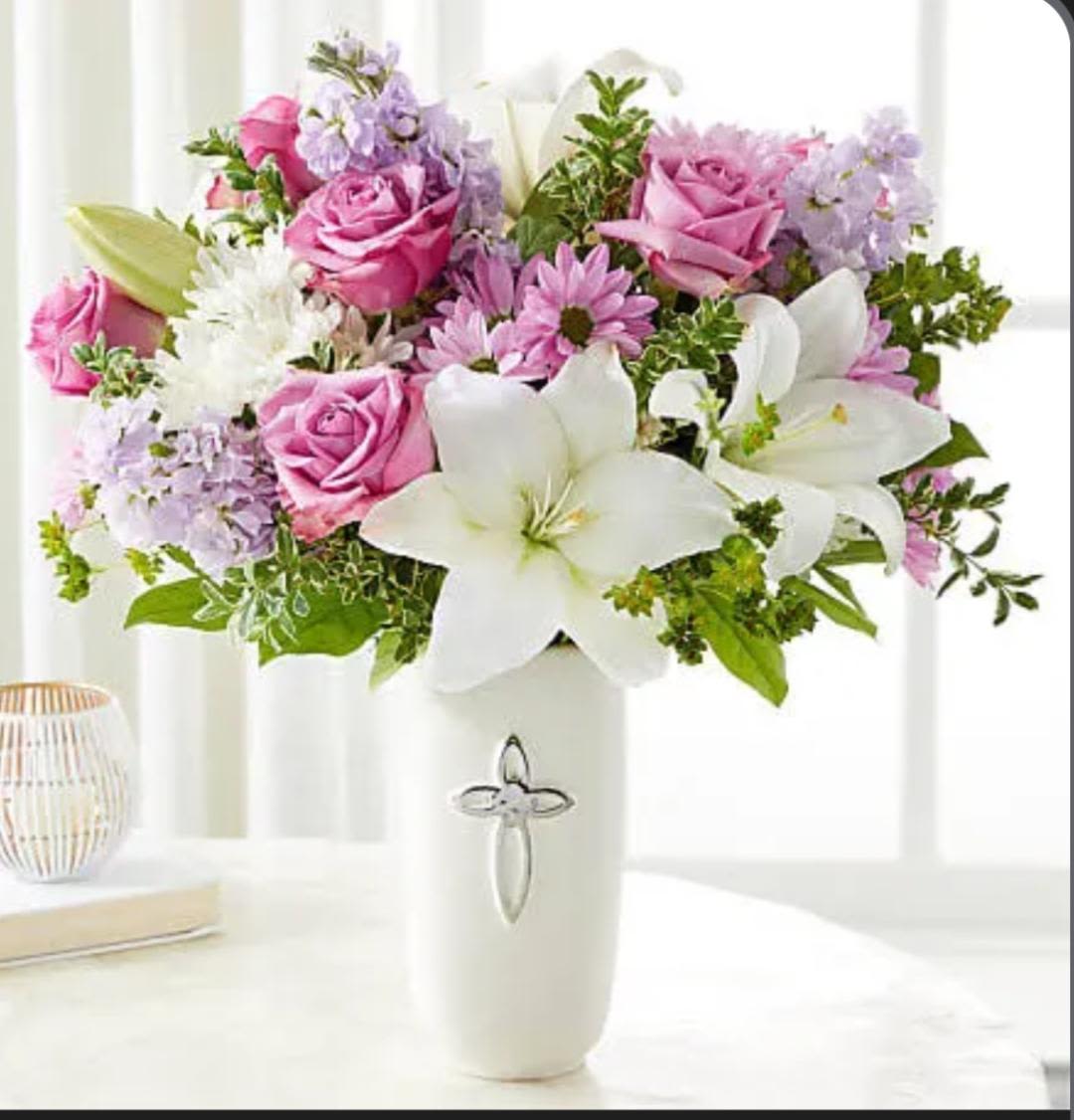 Pink roses and white lilies in a white vase