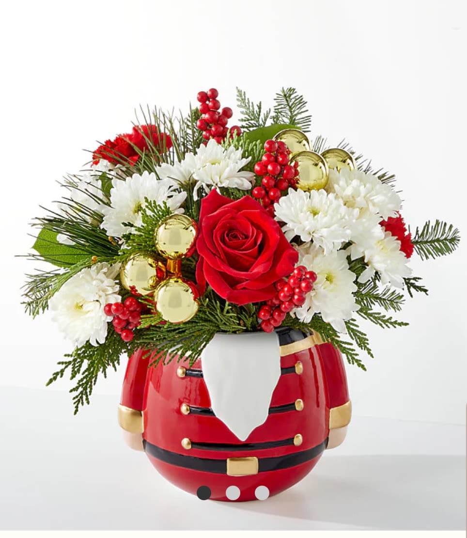 Christmas bouquet in a Santa-shaped vase with red and white flowers