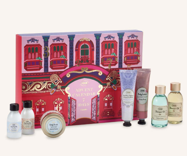 Advent calendar gift box with assorted bath and body products in bottles, tubes, and a tin