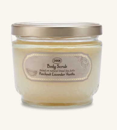 Jar of body scrub with a gold lid and beige label