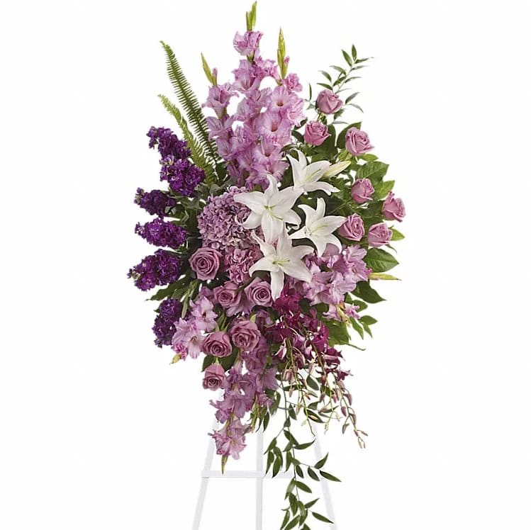 Tall purple and white floral standing spray on an easel