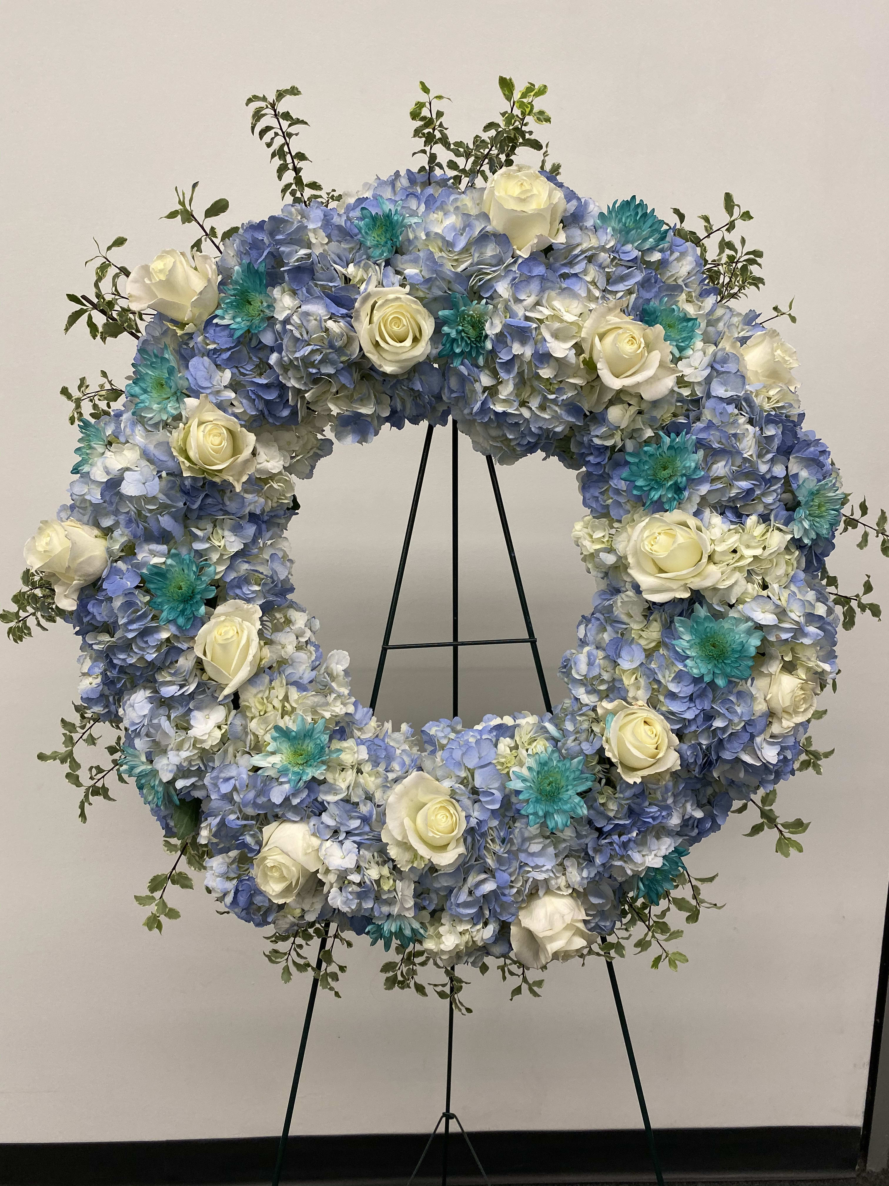 Serenity large spray - Very large wreath of hydrangeas, roses and greenery. Colors are Light blue, white and green.