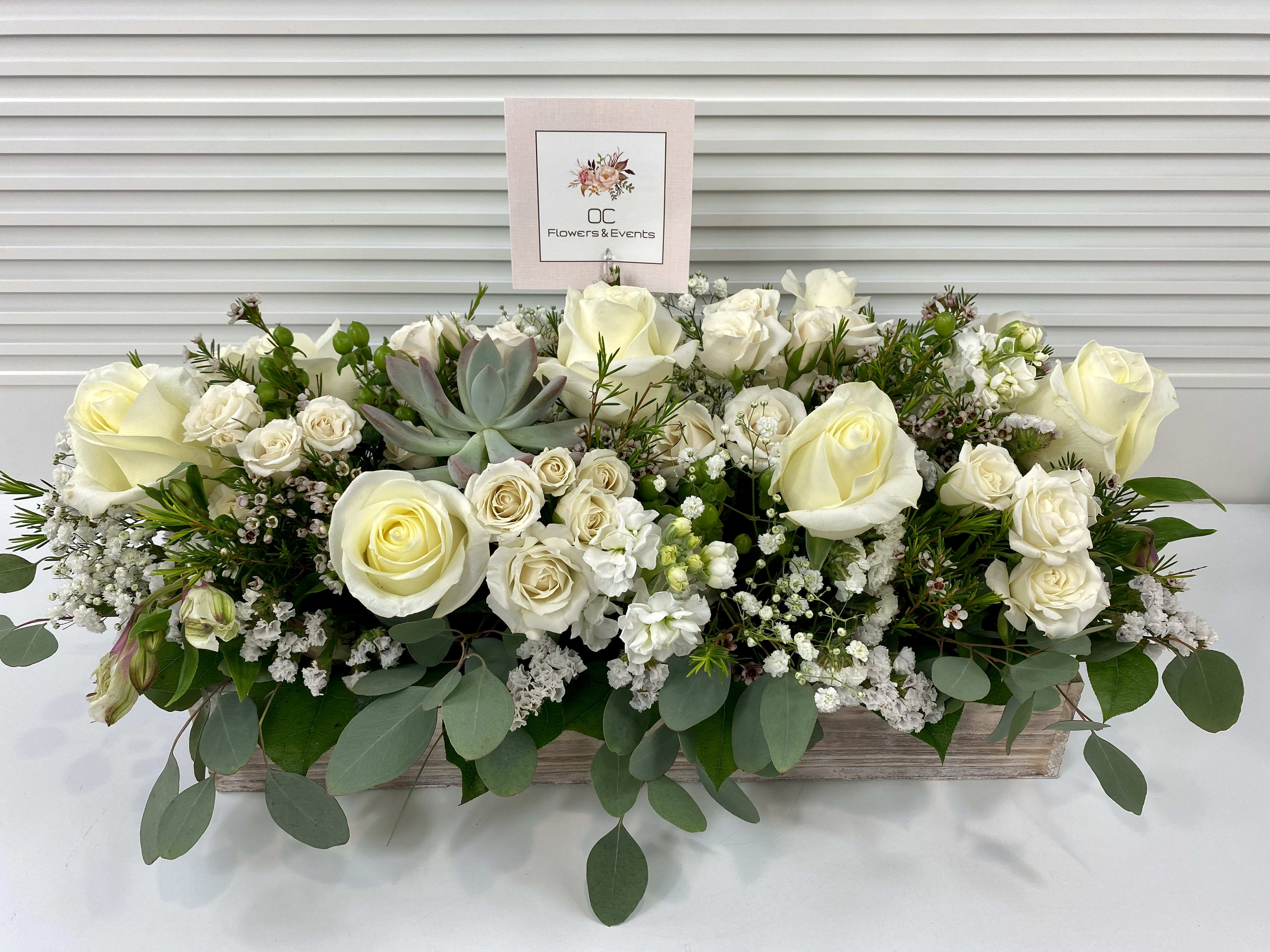 Deepest Sympathy  - Elegant white and green sympathy flower arrangement in a long wooden tray.