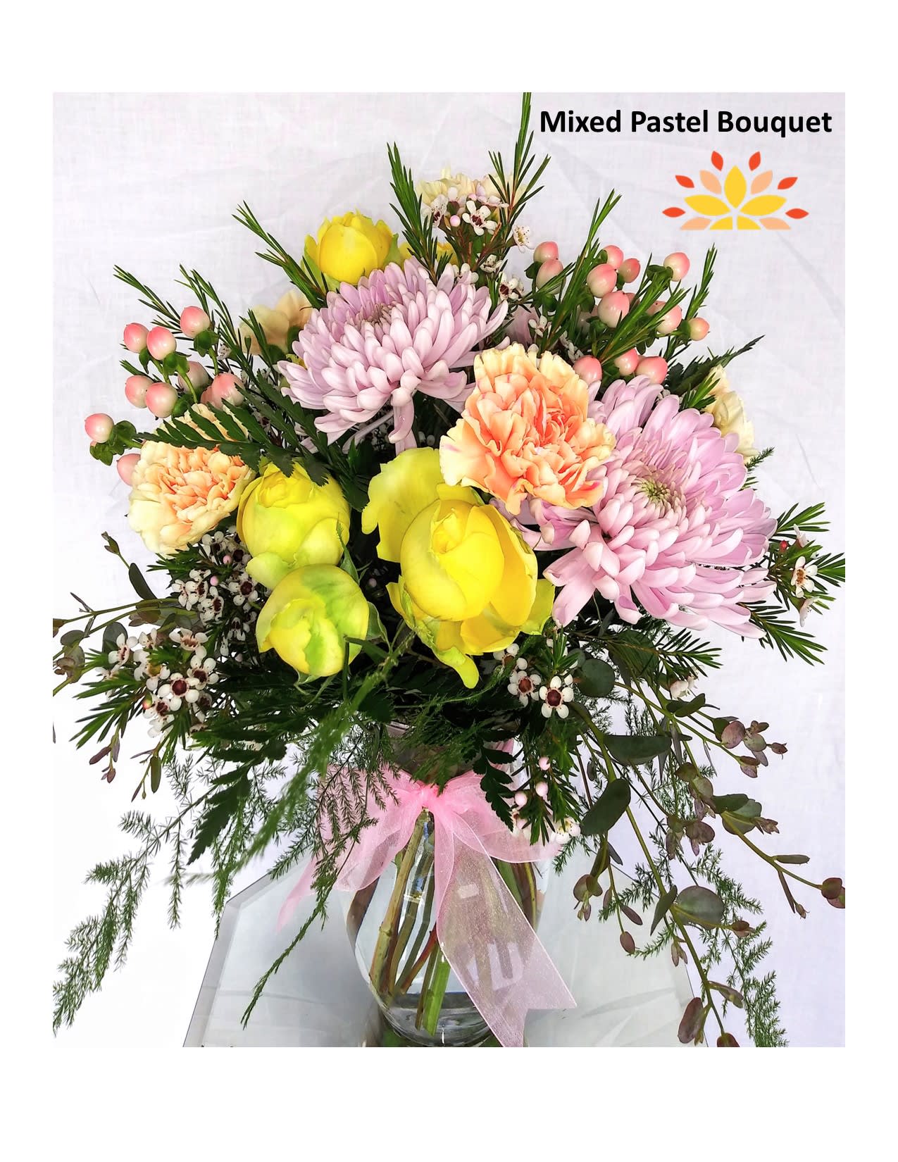 Mixed pastel bouquet in a glass vase with pink and yellow blooms