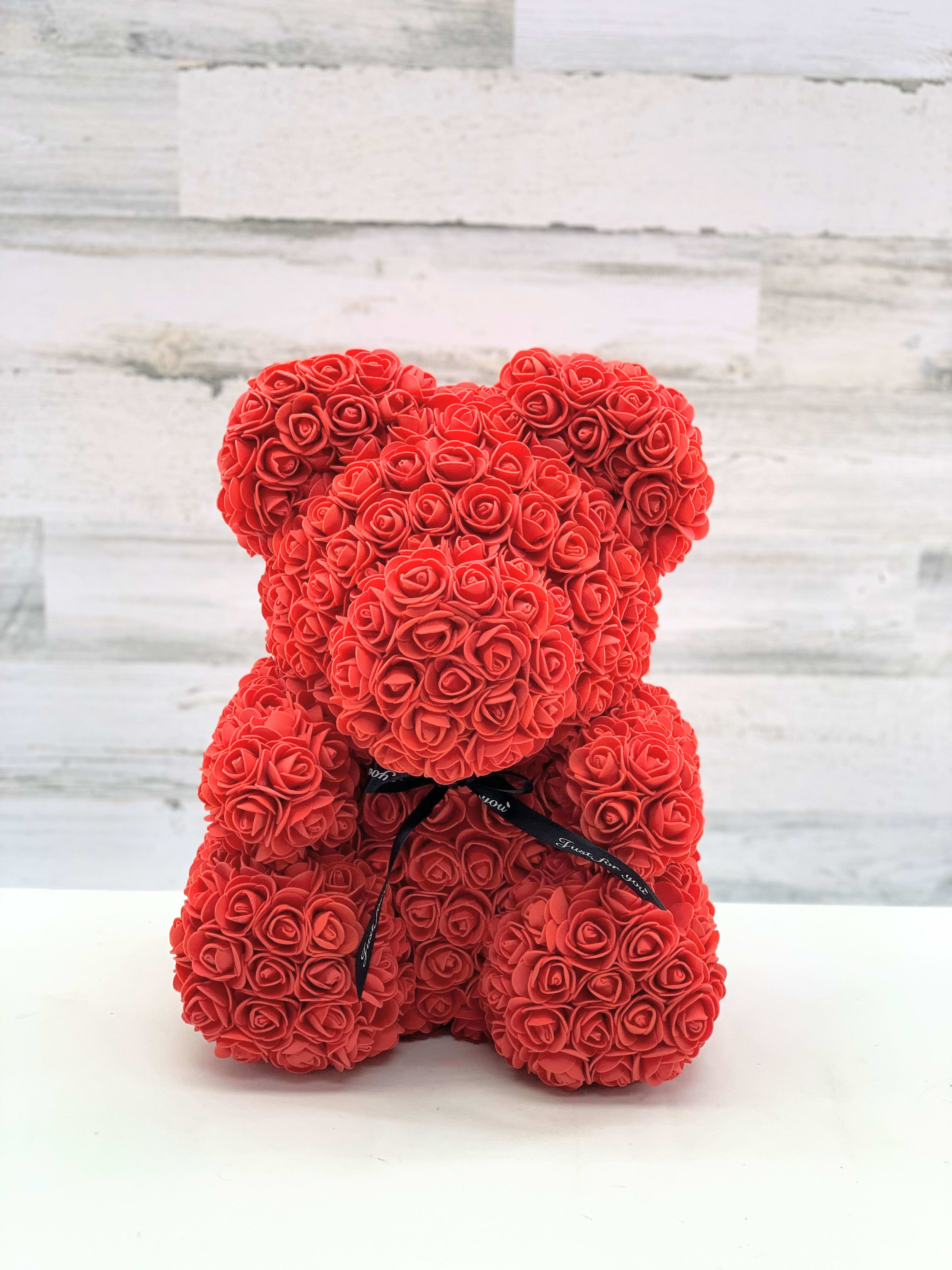 Red rose teddy bear with a black ribbon bow