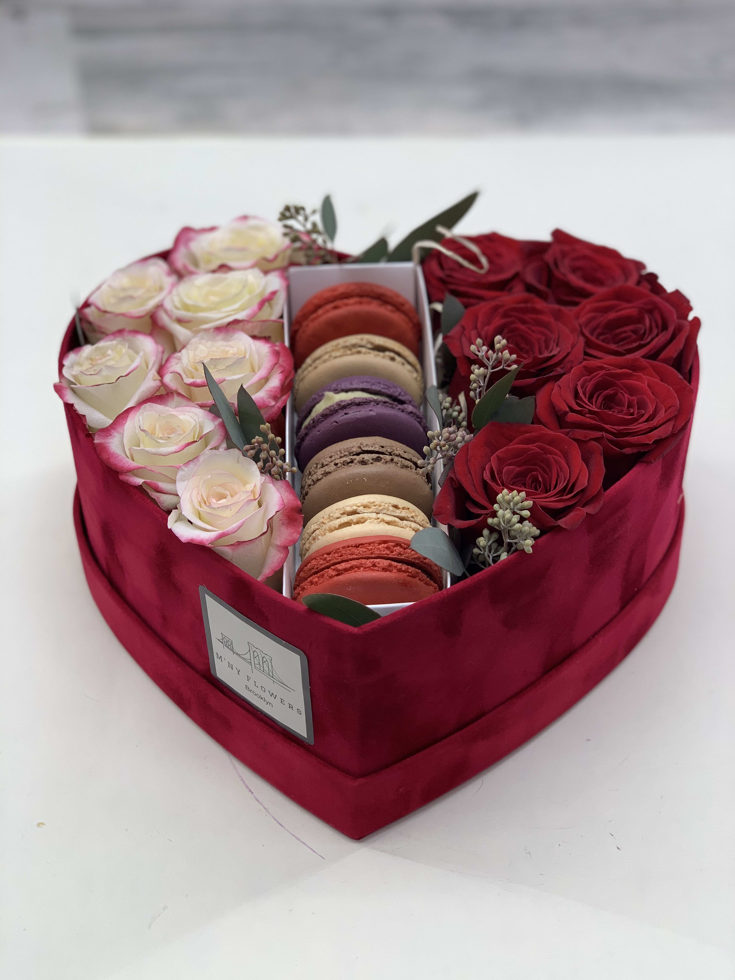 Heart-shaped box with red and white roses and macarons
