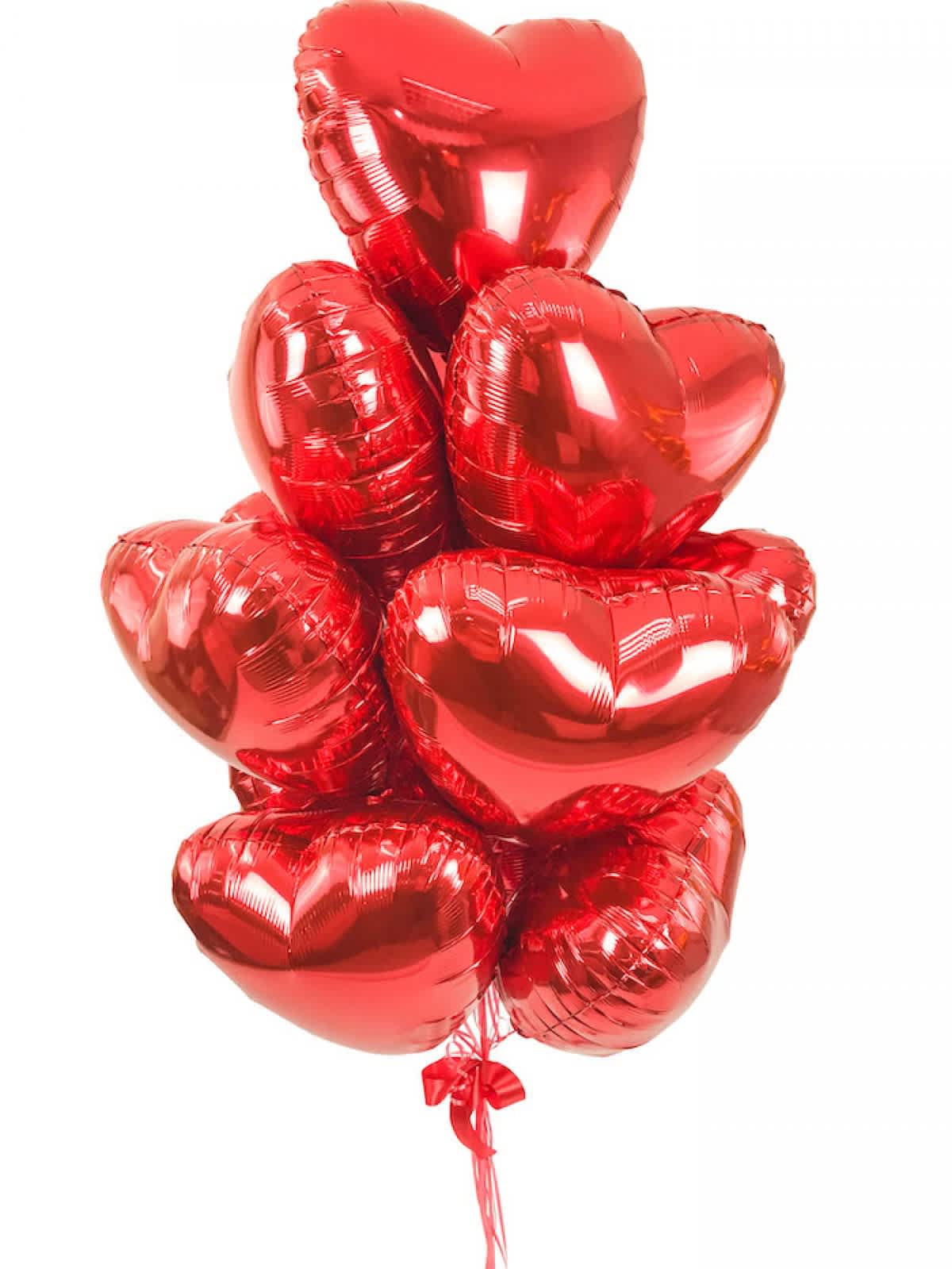 Cluster of red heart-shaped balloons tied together with a ribbon