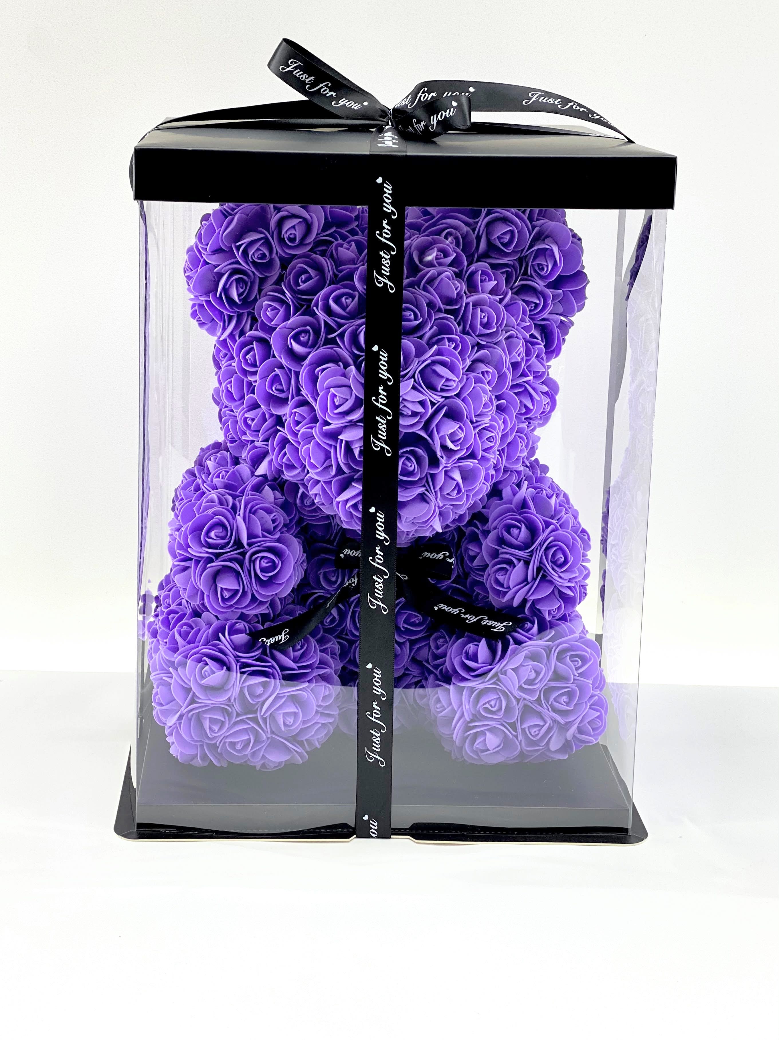 Purple rose teddy bear in a clear gift box with black ribbon