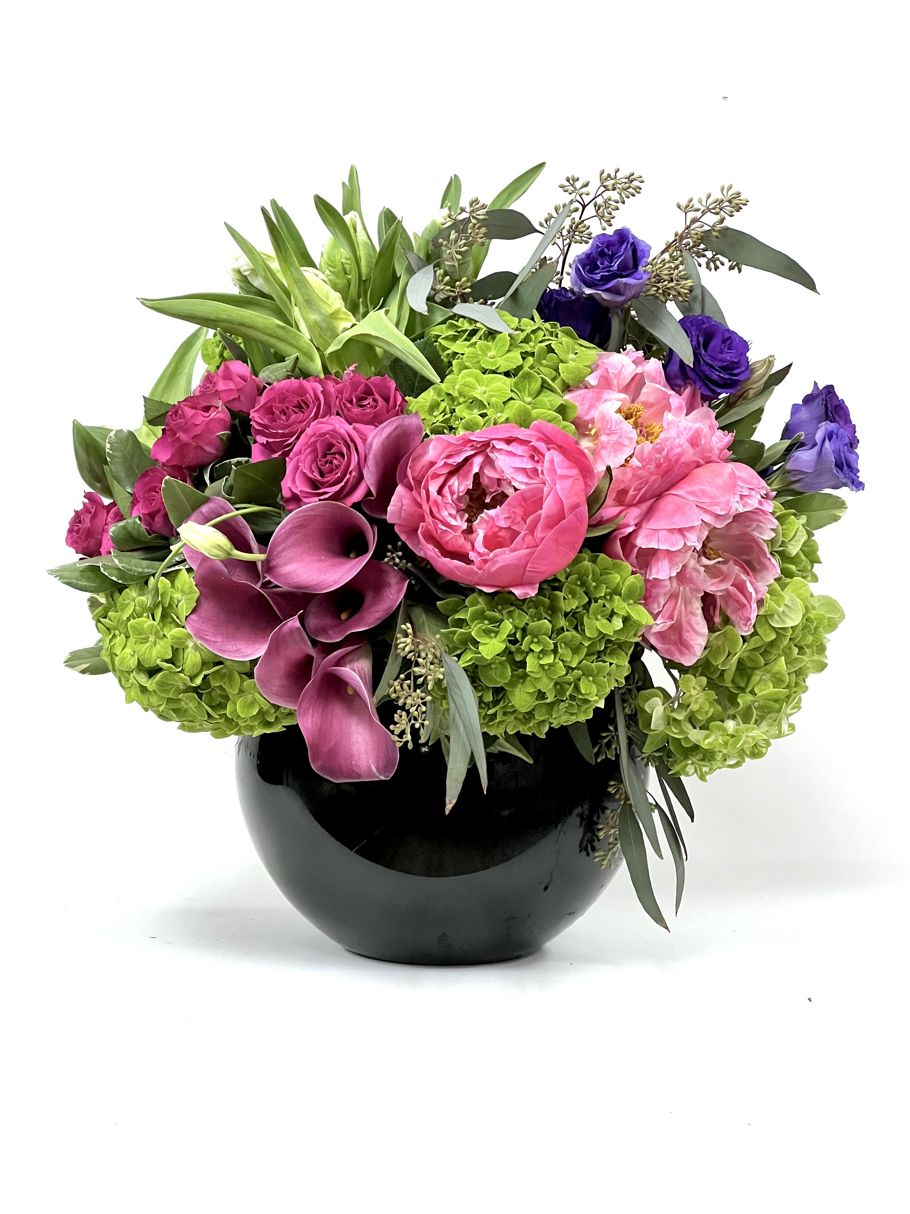 Pink and purple floral arrangement in a black vase