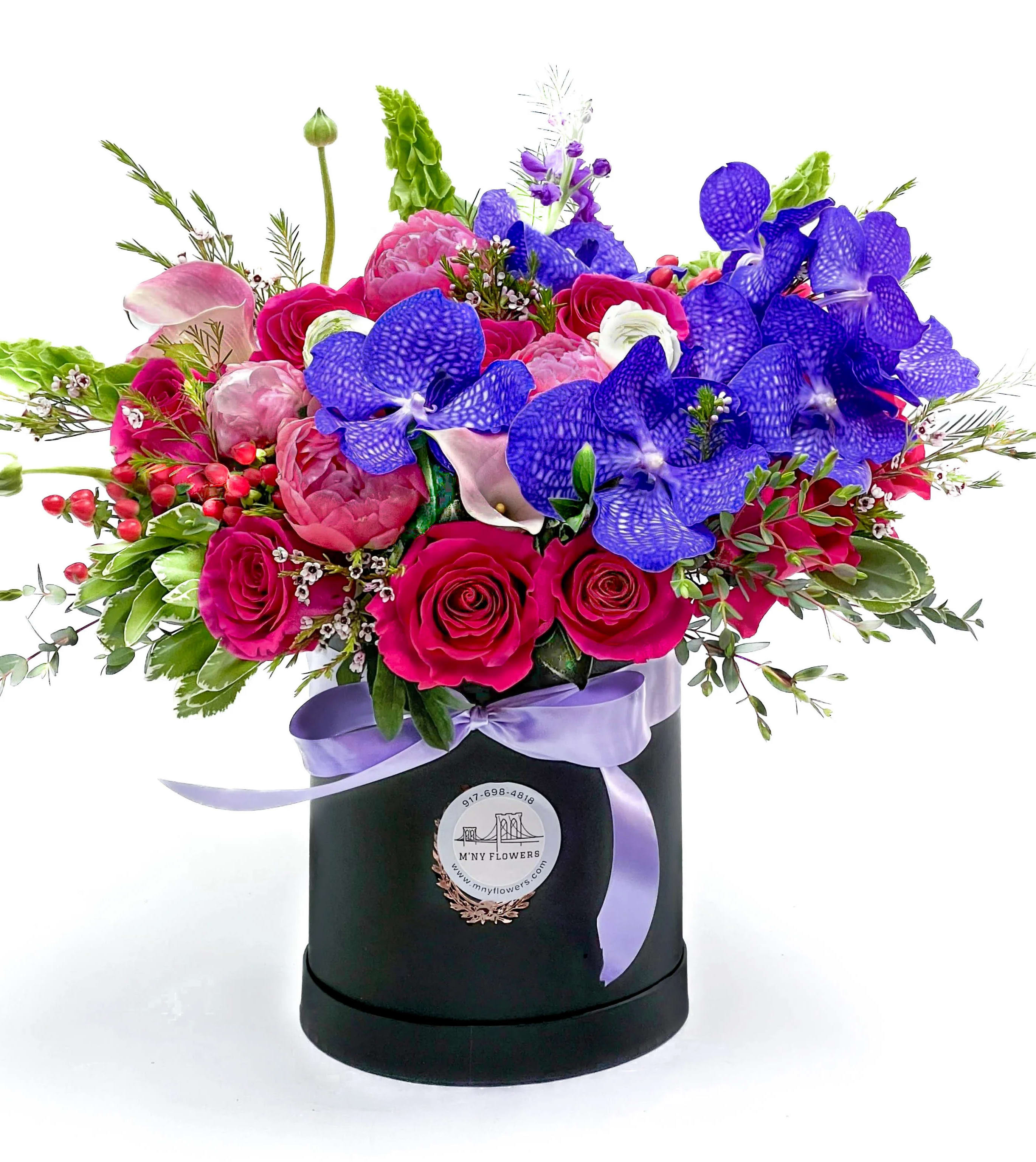 Bright mixed bouquet in a black hatbox with a lavender ribbon