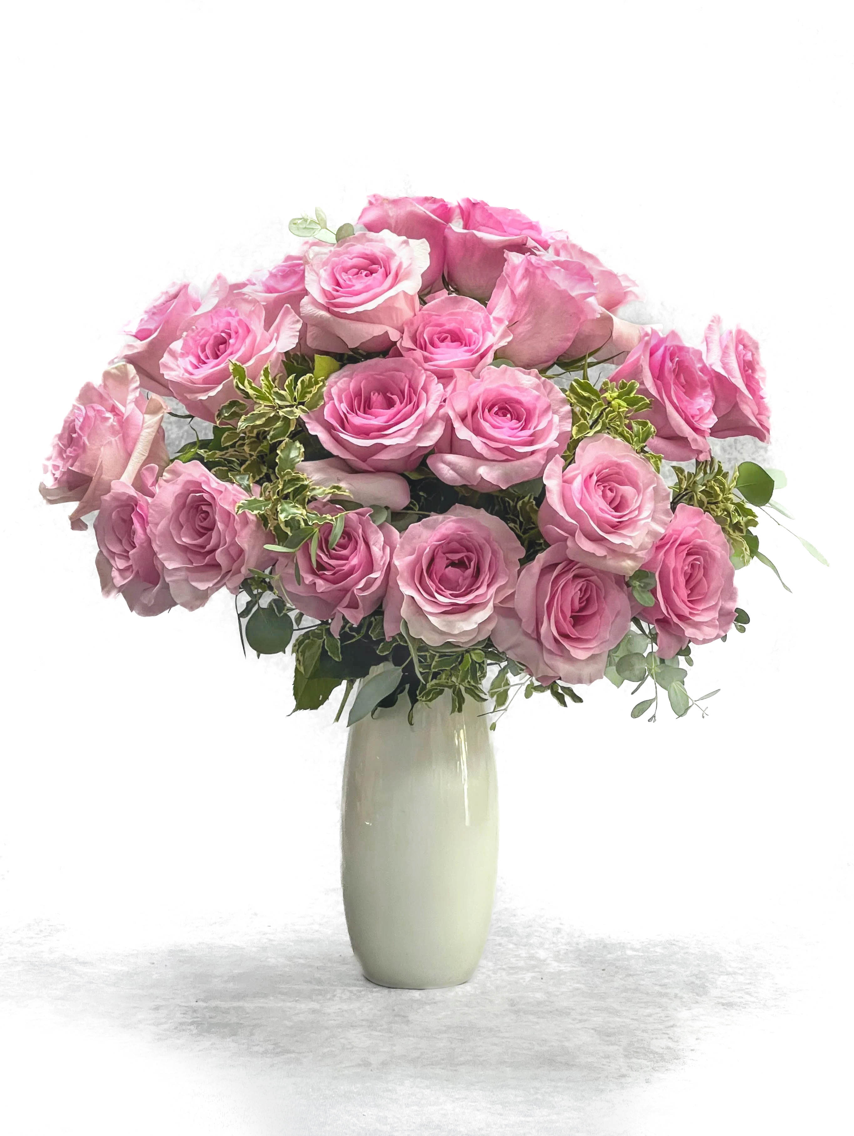 Pink rose bouquet in a tall white vase