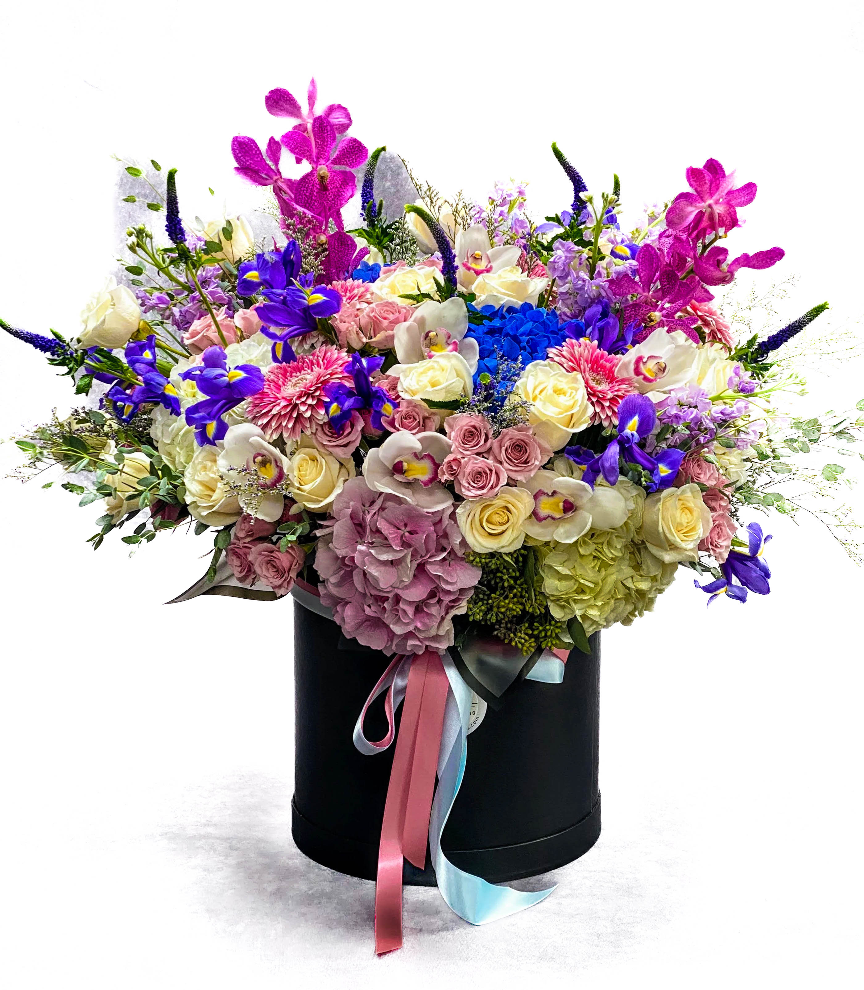 Large mixed bouquet in a black hatbox with pink and blue ribbons