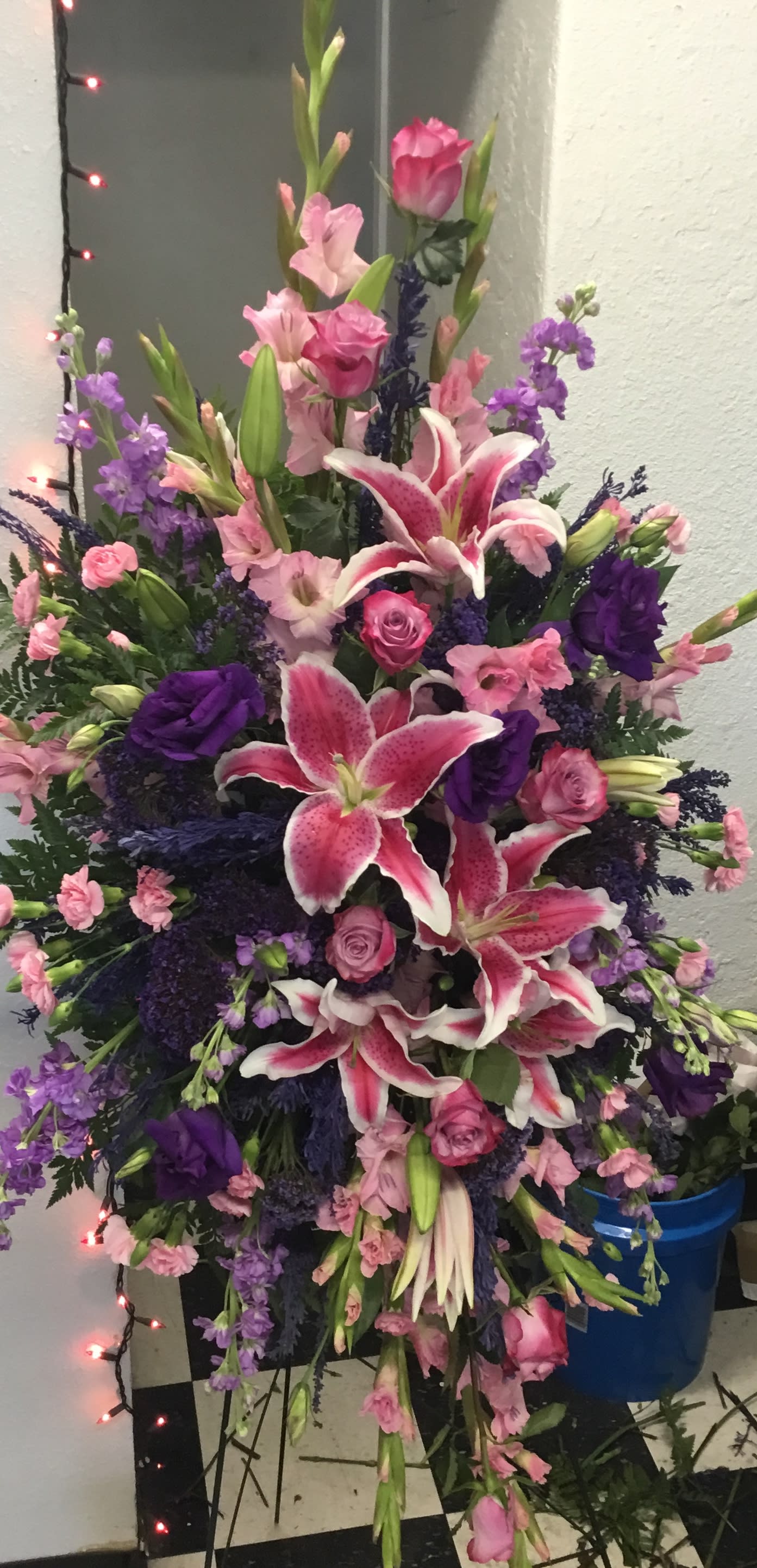 Tall pink and purple floral spray with lilies and roses