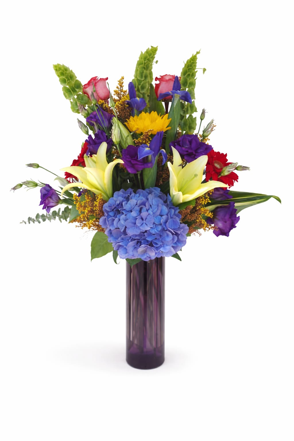 Colorful mixed bouquet in a tall purple glass vase