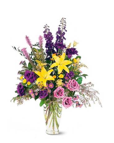 Loving Beauty Bouquet - With its gorgeous yellow and purple flowers, this beautiful arrangement is a reminder that love is everlasting. One arrangement arrives decorated with yellow lilies and purple liatris, asters and roses, in a classic clear glass vase.