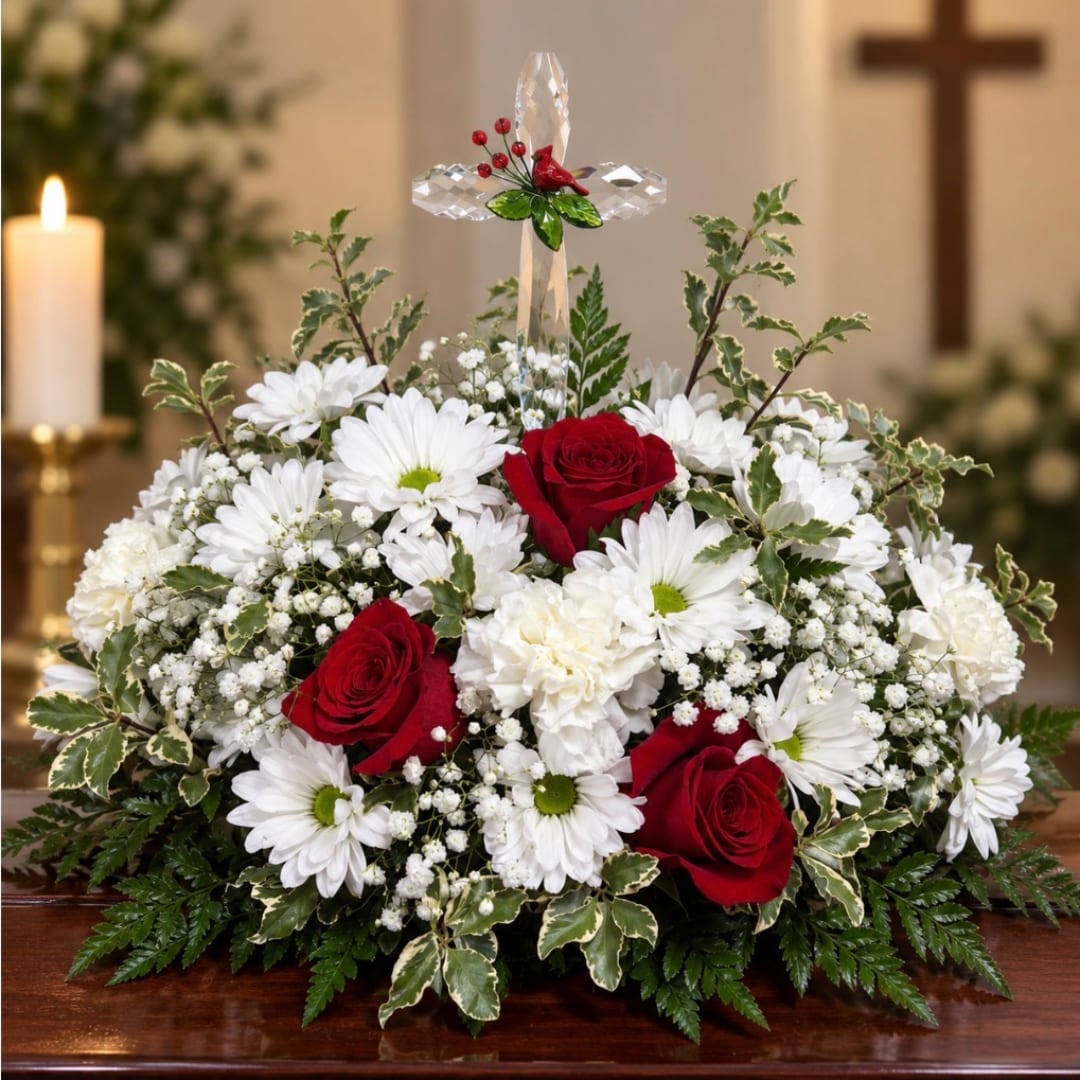 White daisies and red roses arranged with a crystal cross centerpiece