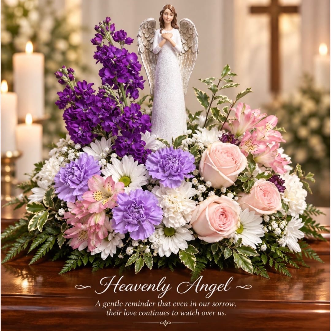 Floral sympathy arrangement with an angel figurine and pink, purple, and white flowers