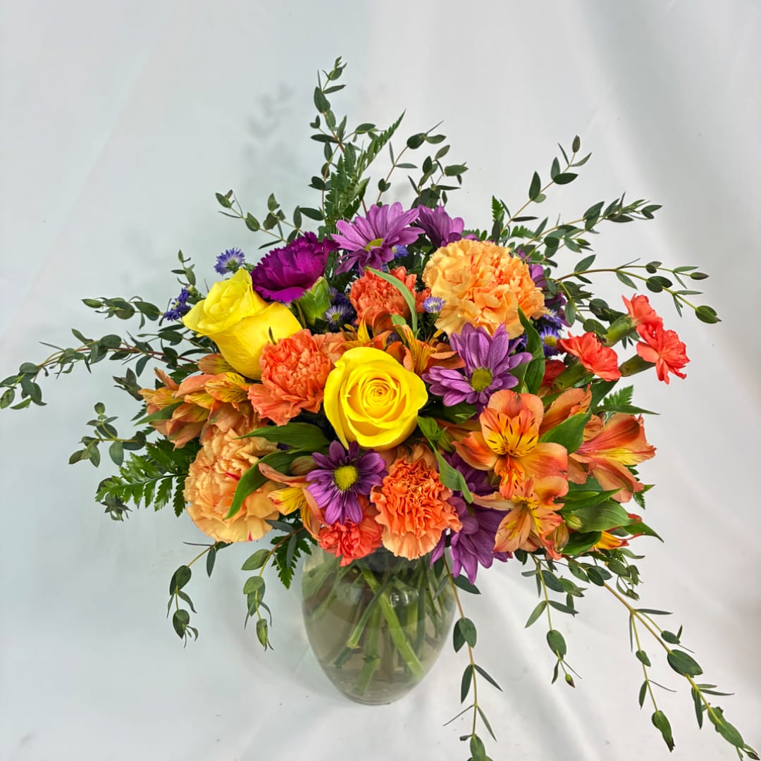 Colorful mixed bouquet in a clear glass vase