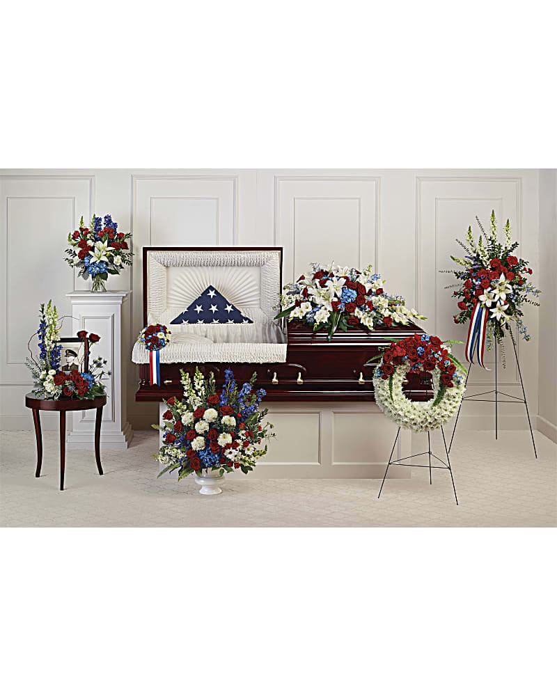 Teleflora's Distinguished Service Collection - Proud and patriotic, this collection of seven hand-made sympathy pieces honors a life of distinguished service with beautiful arrangements of red, white and blue blooms. Teleflora's Distinguished Service Collection includes the following seven sympathy set pieces: Distinguished Service Casket Spray, Loving Legacy Casket Insert, Sacred Duty Spray, Reflections Of Glory Wreath, With Distinction Bouquet DX, Always With Us Photo Tribute Bouquet DX, Colorful Tribute Bouquet DX