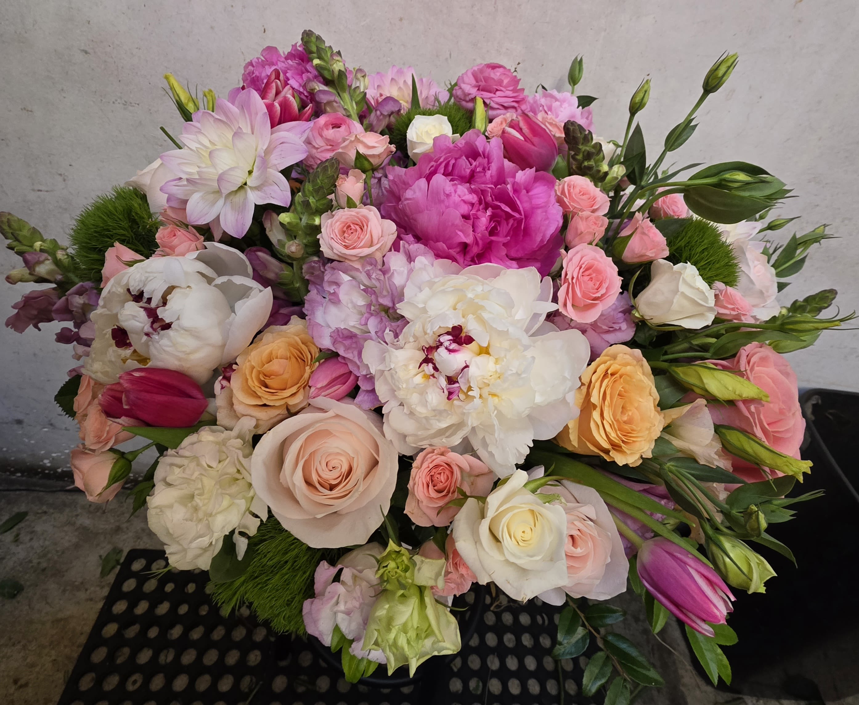 Mixed bouquet of pink, white, and peach flowers