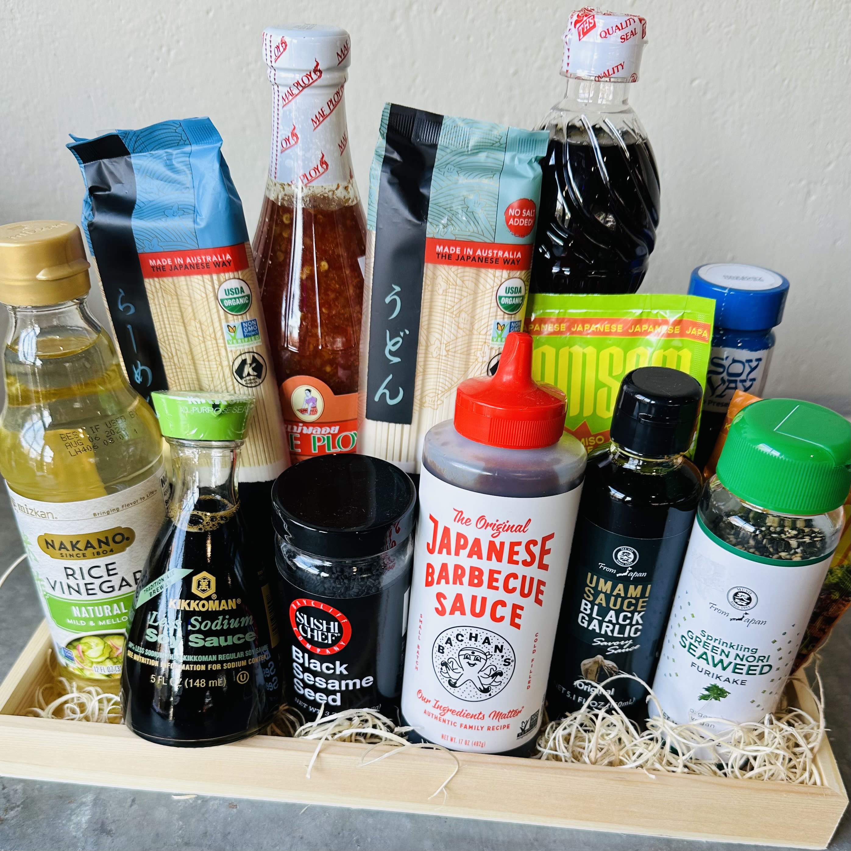 Assorted Japanese sauces and seasonings arranged in a wooden tray