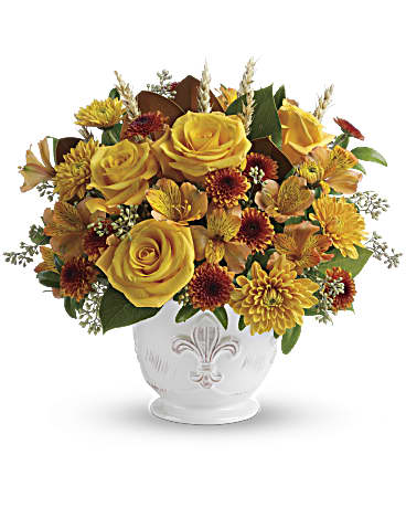 Yellow roses and autumn flowers arranged in a white vase