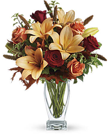 Fall Fantasia - Roses, lilies and oak leaves create a fantasy of fall flowers. Send this tall, elegant arrangement to wish someone a happy autumn or joyous Thanksgiving. The warm color palette and Couture Vase make a stylish seasonal statement.