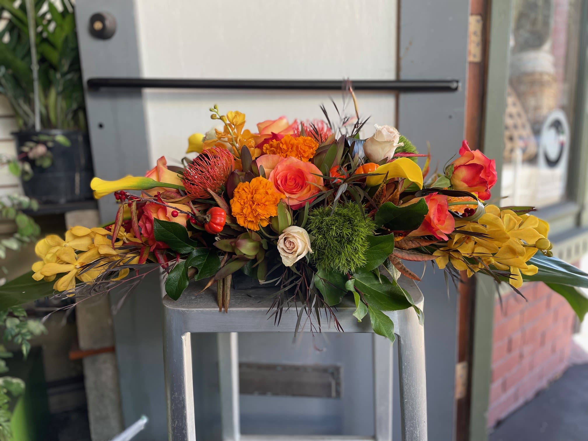 Autumn Centerpiece #3 - This is a great arrangement for your festivities. This arrangement has roses, daffodils, marigolds and more  