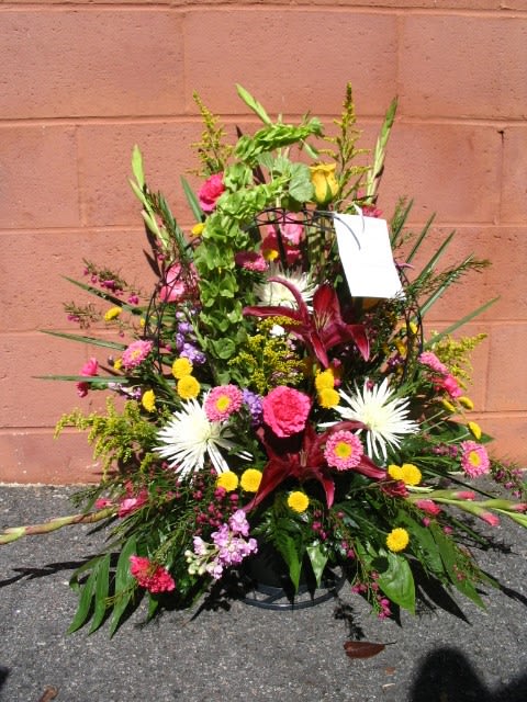Large mixed floral arrangement with pink, yellow, and white blooms