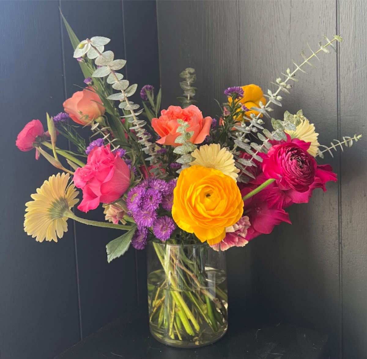 LARGE SEASONAL ARRANGEMENT IN GLASS VASE, DESIGNER'S CHOICE - Seasonal, colorful flowers and foliage artfully arranged in a clear glass vase.  Year round flowers that we typically stock: specialty rose, spray rose and garden rose, ranunculus, anemone, gerbera daisy, protea, lisianthus, chrysanthemum, larkspur, snapdragon, delphinium, stock, aster, dianthus, hypericum, feverfew, astrantia, leucodendron.