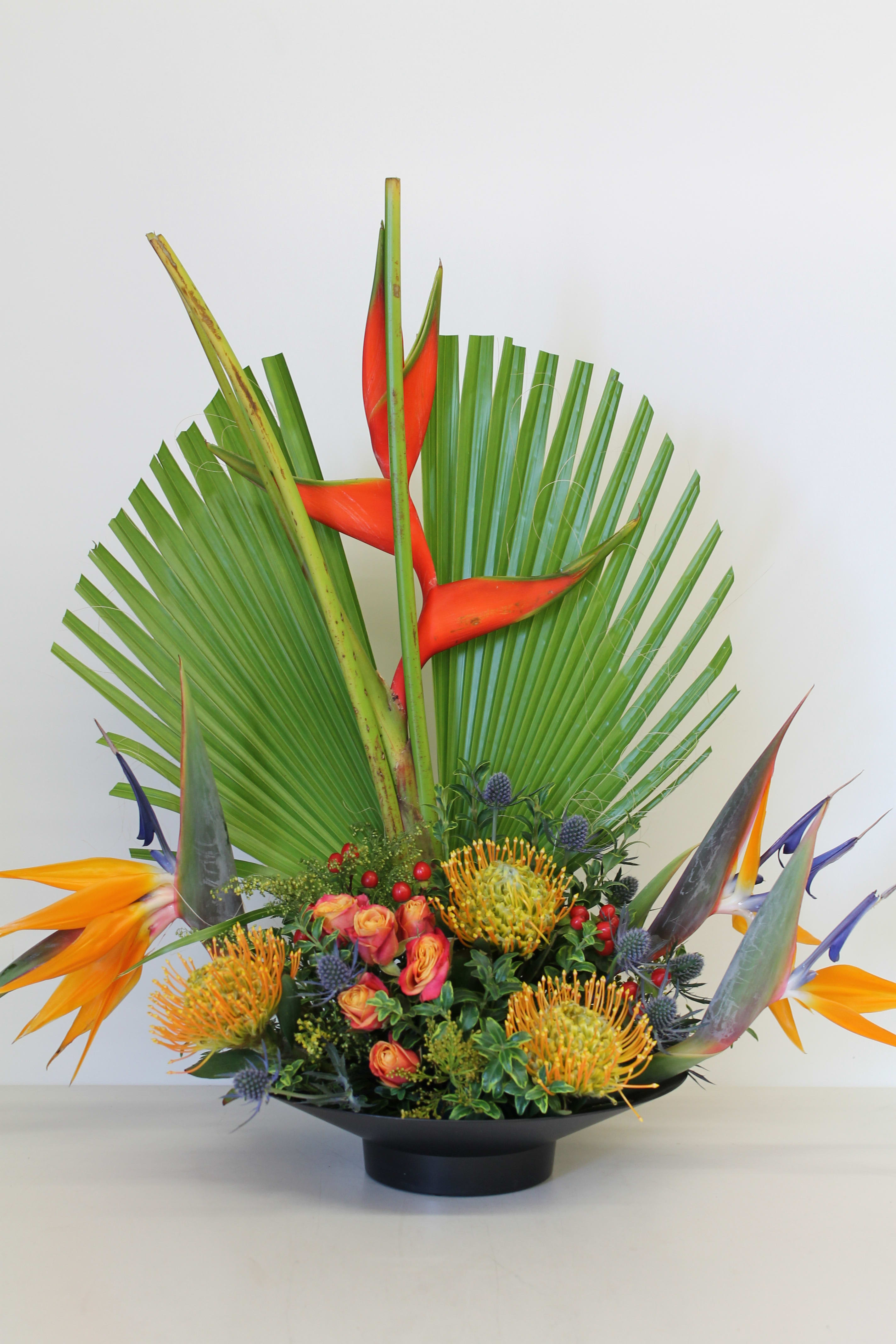 Tropical Bird - Bird of Paradise, Pin Cushion, Sea Holy, Heliconia, Spray Rose, Hypericum, Solidago and Palm Leaf