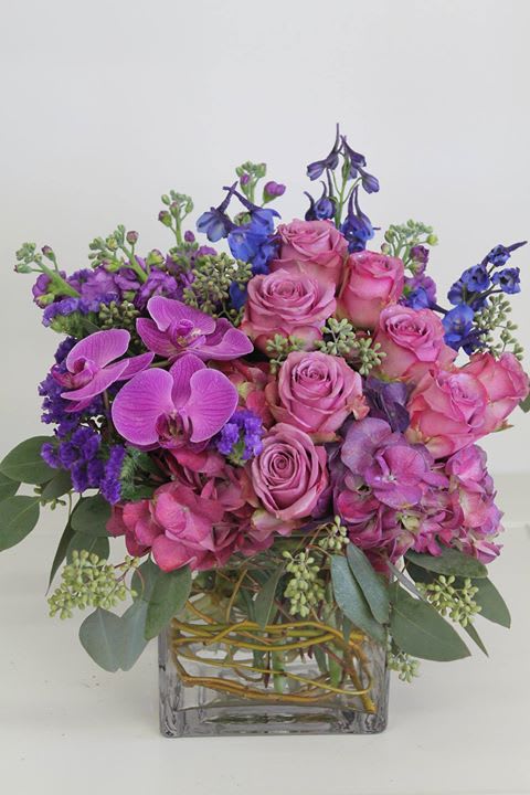 Lovely - In this arrangement Hydrangea, Roses, Orchids, Delphinium, Stock and seeded Eucalyptus have been arranged in a large cube.