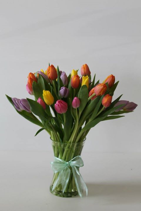 The Dancing Tulips - This arrangement contains a total of 40 tulips arranged in a vase with a matching ribbon around the it.
