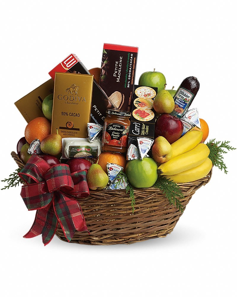 Large wicker gift basket filled with assorted fruits, gourmet snacks, and chocolates with a plaid bow.