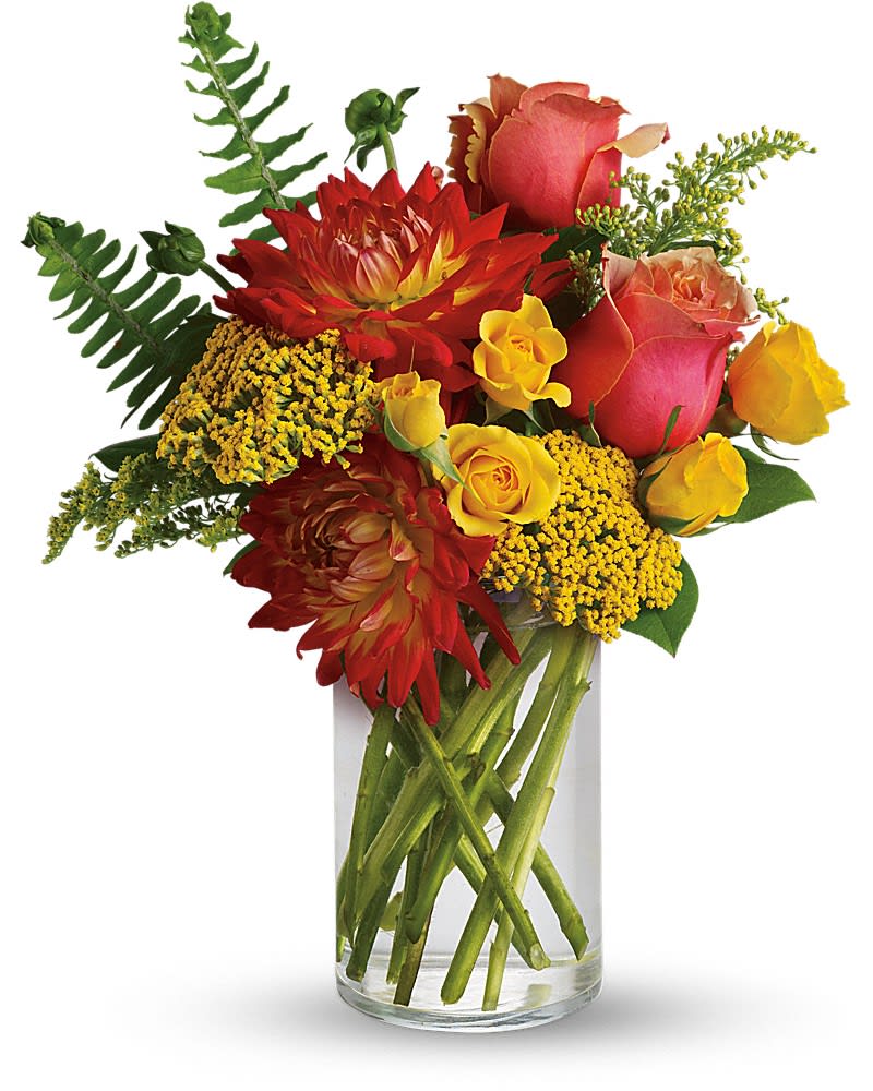Red and yellow mixed flower arrangement with roses in a clear glass cylinder vase