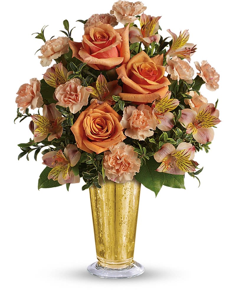 Arrangement of peach and orange roses, carnations, and alstroemeria in a tall gold vase