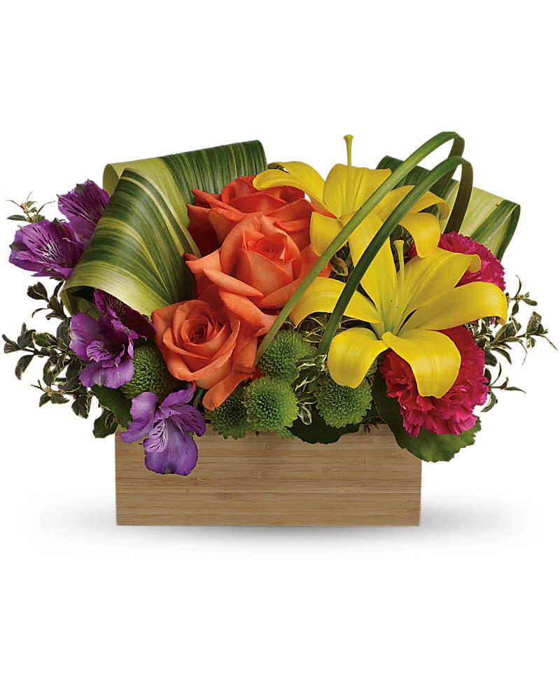 Low rectangular arrangement of yellow lilies, orange roses, purple blooms, and green mums in a wooden box