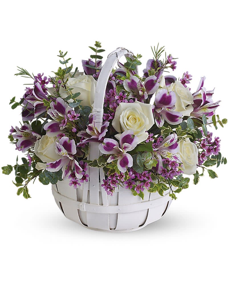White basket of white roses and purple and white alstroemeria with small purple blossoms