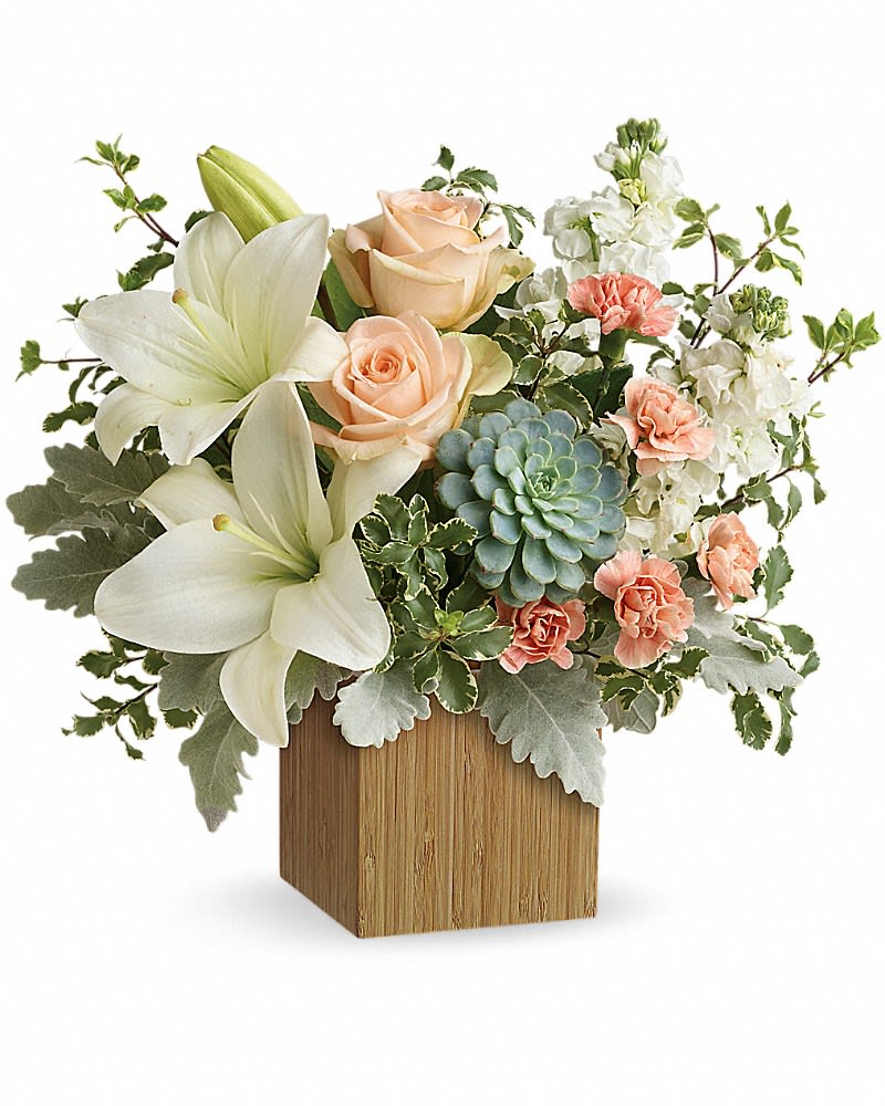 Compact arrangement of white lilies, peach roses, carnations and succulent in a wooden cube