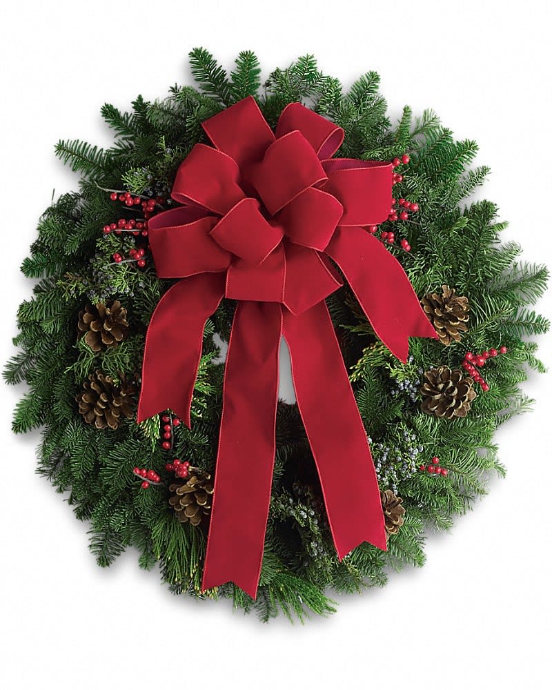 Evergreen wreath with a large red bow, pinecones, and red berries
