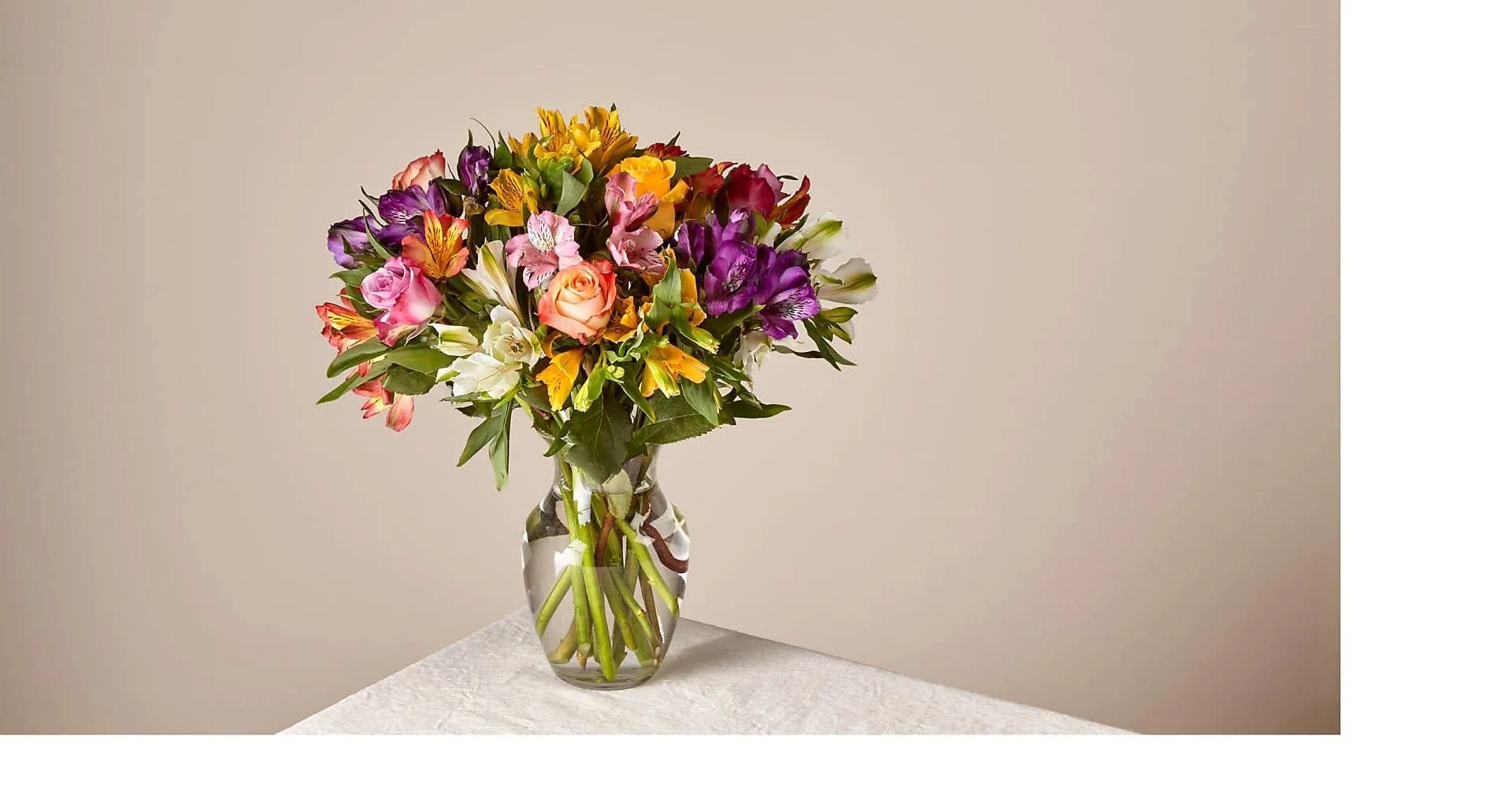 smiles and sunshine - Bring a rainbow of color to any home with this bouquet. Blooming with an assortment of alstroemeria and roses, this vibrant beauty makes the perfect expression for Mother's Day or any springtime occasion.