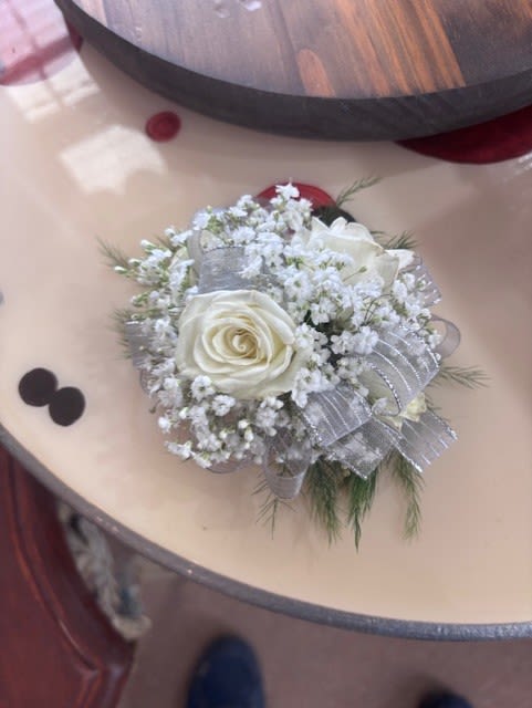 White Spray Rose Corsage - A dreamy finishing touch to a wedding gown, a prom dress, or any other special-occasion finery. Consisting of carefully selected white spray roses complemented with baby’s-breath and greenery,