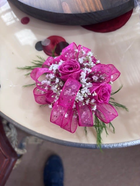 Pink Spray Rose Corsage - A dreamy finishing touch to a wedding gown, a prom dress, or any other special-occasion finery. Consisting of carefully selected white spray roses complemented with baby’s-breath and greenery,
