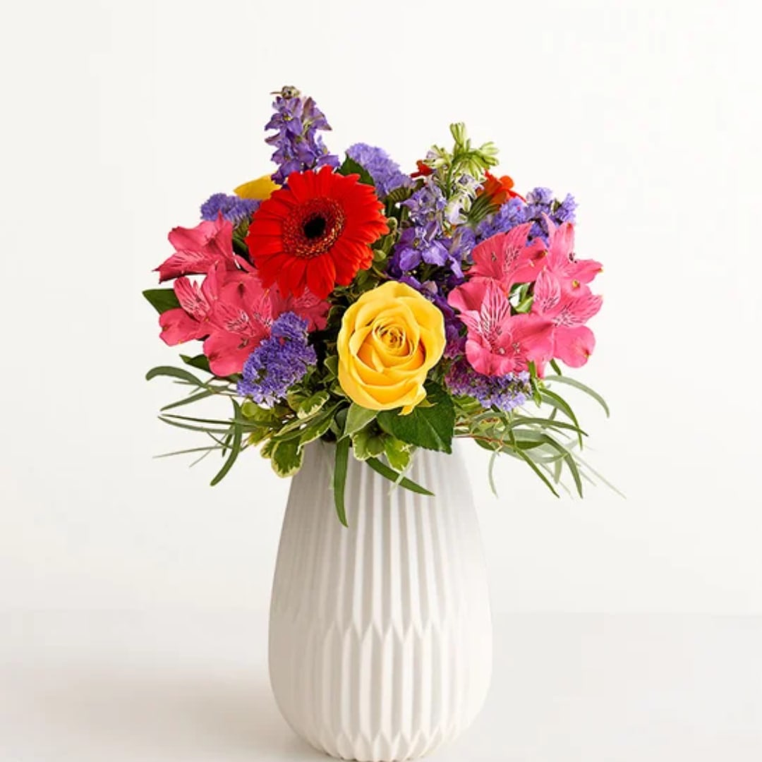 Colorful mixed bouquet in a white vase