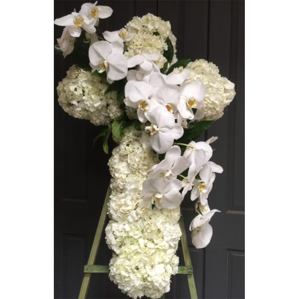 White Cross - White cross arranged with hydrangea and orchids. 