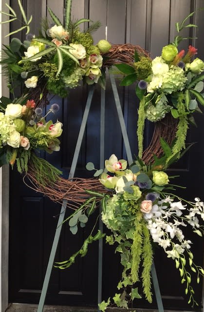 Rustic Remembrance  - Easel display with a grapevine wreath mounted. Wonderful mixed selection of floral in shades of white and green with hint of blue. Timeless remembrance of anyone special.  