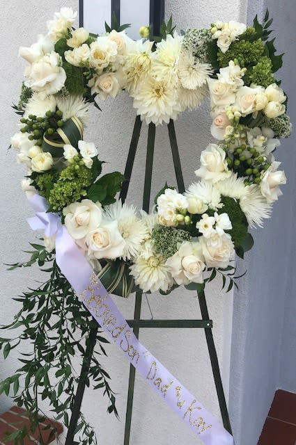 Blessed - Standing open heart easel for celebrating our passed loved ones. Elegant neutral display.  Banner can be placed with a small sentiment or none at all.  Floral typically, hydrangea, roses,ruskus, spider mums, green coffee berry, phlax and white tric and any other premium floral that might be in at the time. 