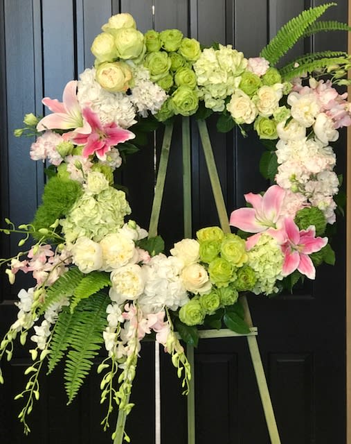Feminine wreath  - A gorgeous wreath on a easel in warm shades. White green and pinks with a abundance of texture 