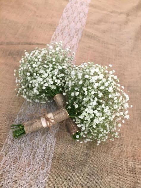 Two small white baby's breath bouquets tied with ribbon and lace